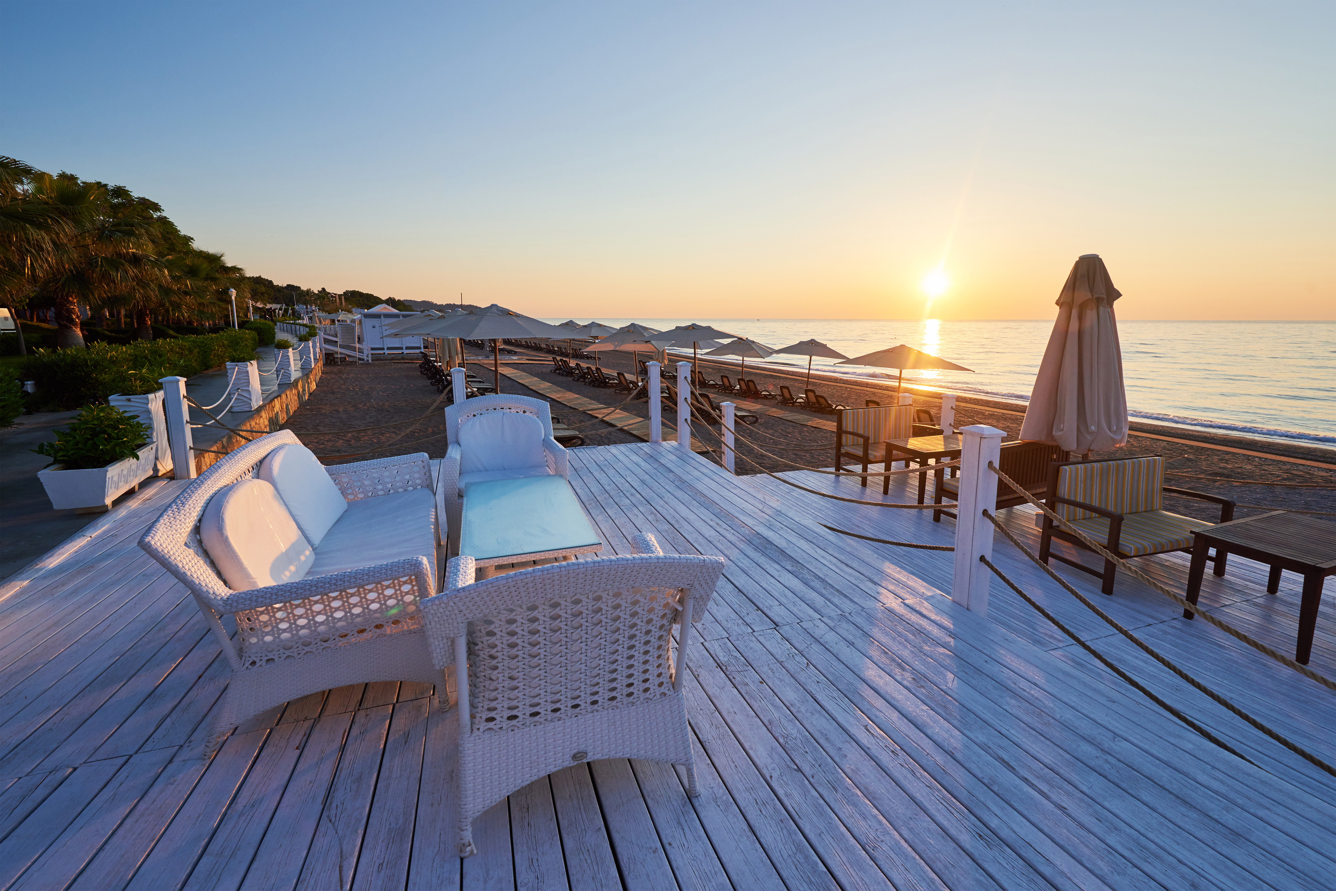 Scenic View Of Sandy Beach On The Beach With Sun Beds And Umbrellas Open Against The Sea And Mountains. Hotel. Resort. Tekirova Kemer Scenic View Of Sandy Beach On The Beach With Sun Beds And Umbrellas Open Against The Sea And Mountains. Hotel. Resort. Tekirova Kemer